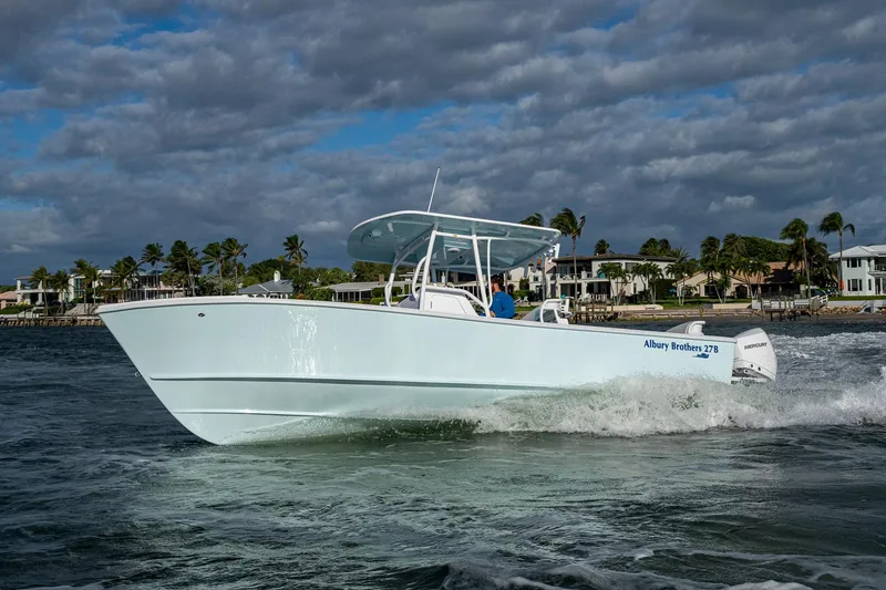 Slide: The Image of 2026 Albury Brothers 27 boat cruising on water near coastal homes. - 4