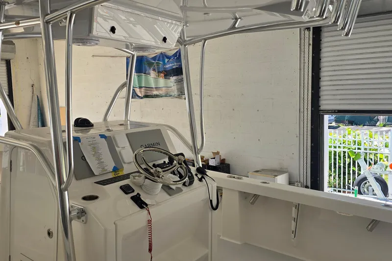 Slide: The Image of 2026 Albury Brothers 27 boat interior with steering wheel and Garmin navigation system. - 6