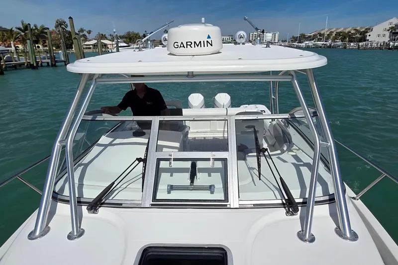 Slide: The Image of 2007 Boston Whaler 305 Conquest boat with Garmin equipment on turquoise water. - 11