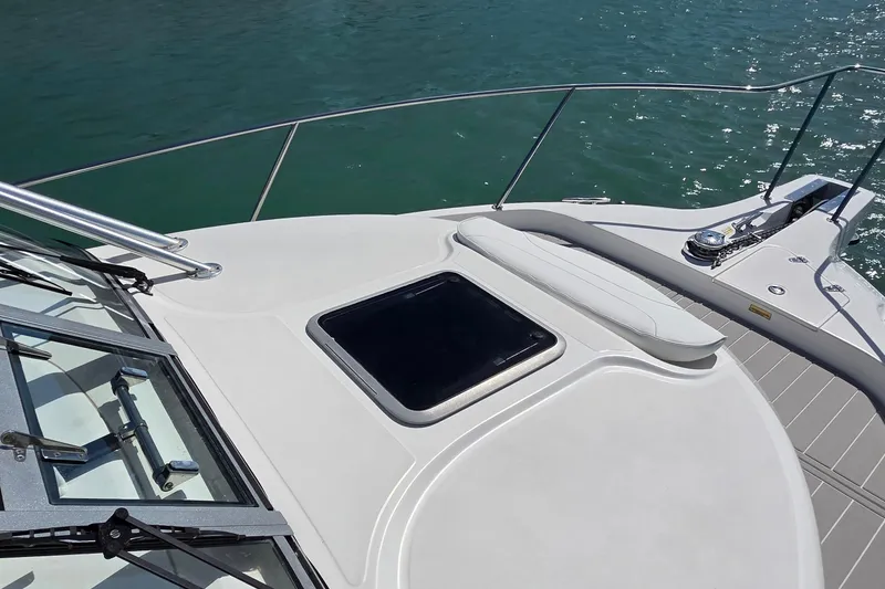Slide: The Image of 2007 Boston Whaler 305 Conquest boat deck with hatch, railing, and water view. - 13
