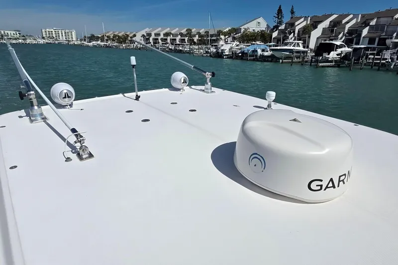 Slide: The Image of 2007 Boston Whaler 305 Conquest boat with Garmin equipment, docked in a marina. - 16