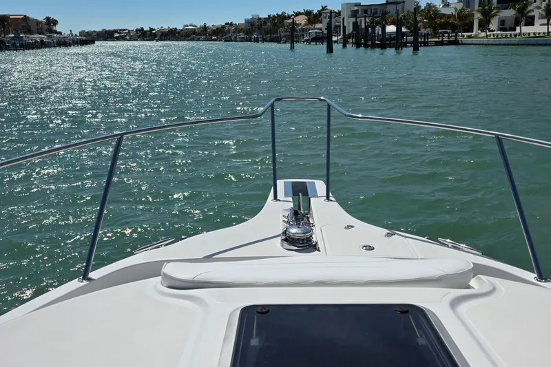 Slide: The Image of 2007 Boston Whaler 305 Conquest boat on sparkling water, sunny day, coastal view. - 2
