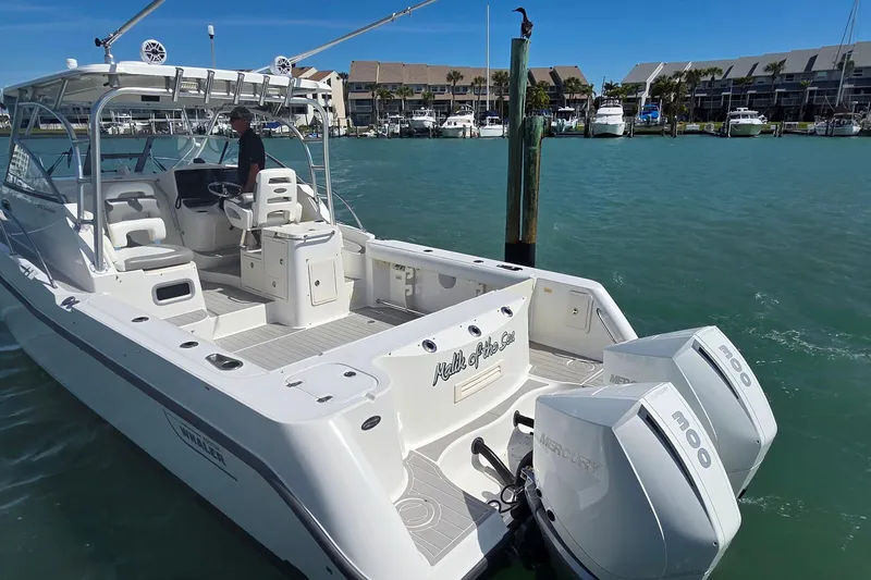 Slide: The Image of 2007 Boston Whaler 305 Conquest boat docked with twin Mercury engines. - 29