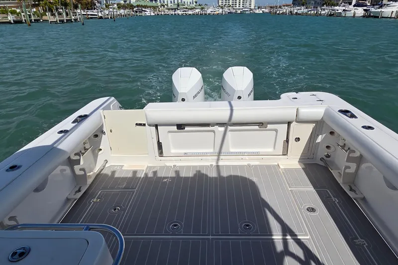 Slide: The Image of 2007 Boston Whaler 305 Conquest boat deck with twin Mercury engines on water. - 3