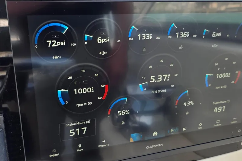 Slide: The Image of Dashboard of a 2007 Boston Whaler 305 Conquest showing engine metrics on a Garmin display. - 31