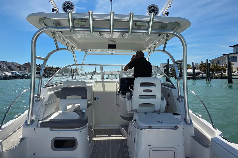 Slide: The Image of 2007 Boston Whaler 305 Conquest boat interior with helm, seats, and ocean view. - 4