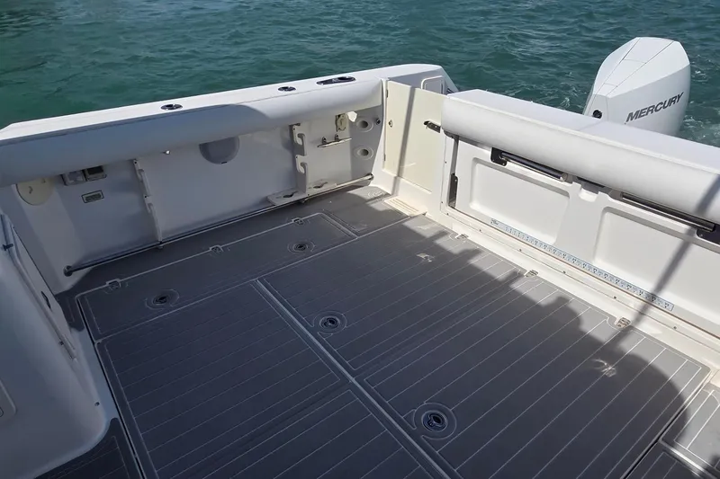 Slide: The Image of 2007 Boston Whaler 305 Conquest boat deck with Mercury engine, on calm water. - 5