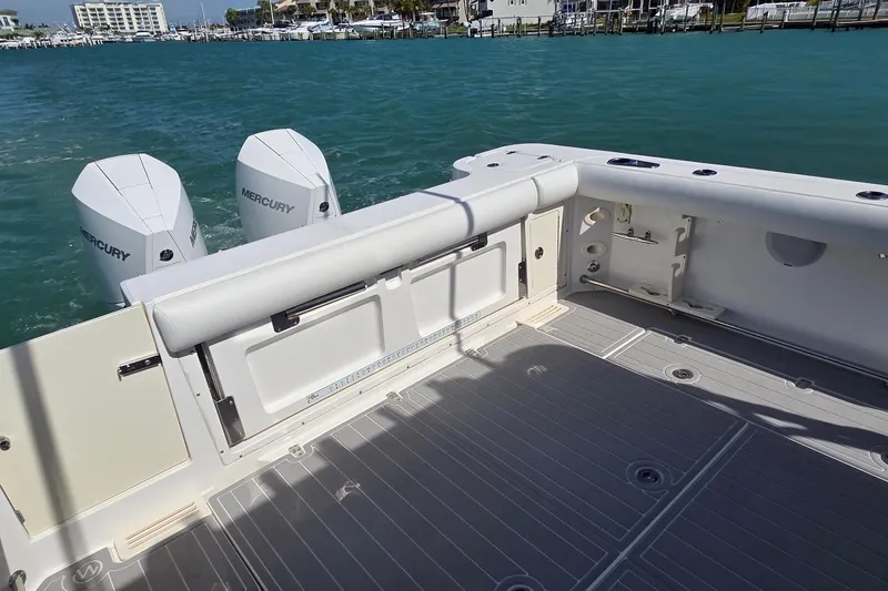 Slide: The Image of 2007 Boston Whaler 305 Conquest boat deck with twin Mercury engines on blue water. - 6