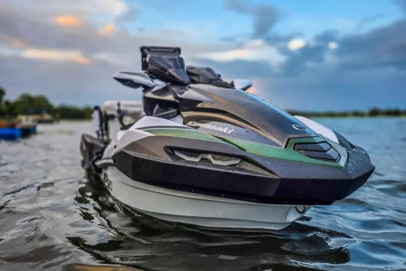 Slide: The Image of 2025 Kawasaki Ultra 160LX-S Angler jet ski on water at sunset. - 11