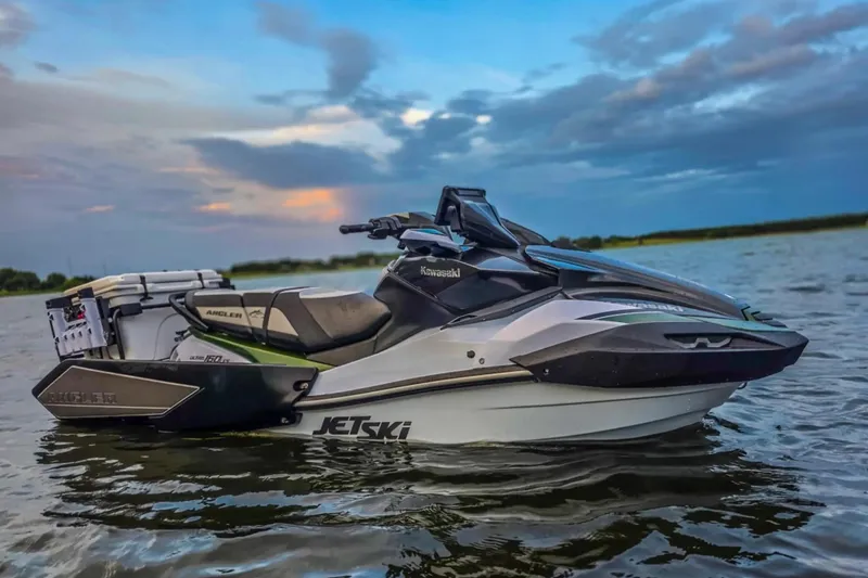 Slide: The Image of 2025 Kawasaki Ultra 160LX-S Angler jet ski on water at sunset. - 4