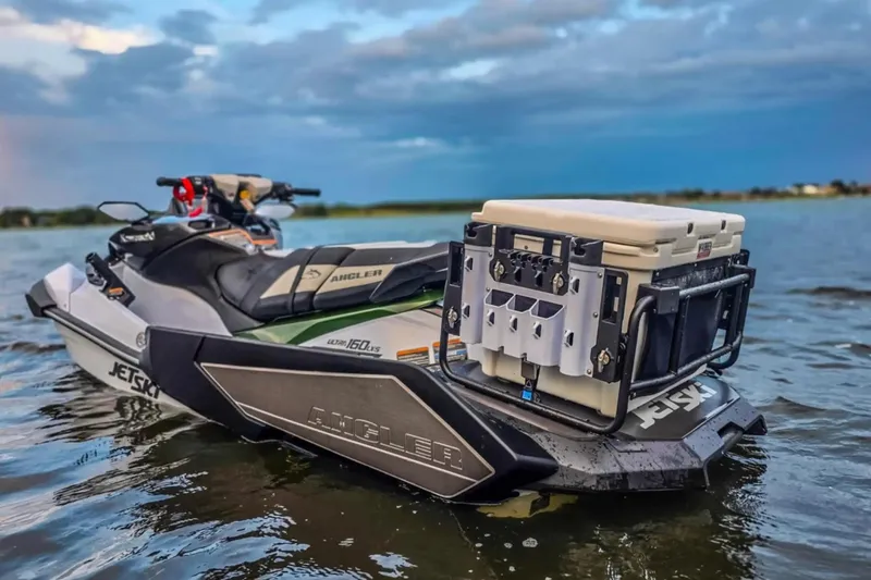 Slide: The Image of 2025 Kawasaki Ultra 160LX-S Angler jet ski on water, equipped for fishing. - 6