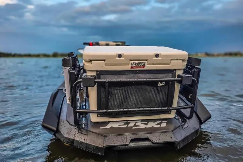 Slide: The Image of 2025 Kawasaki Ultra 160LX-S Angler jet ski with fishing gear on a calm lake. - 7