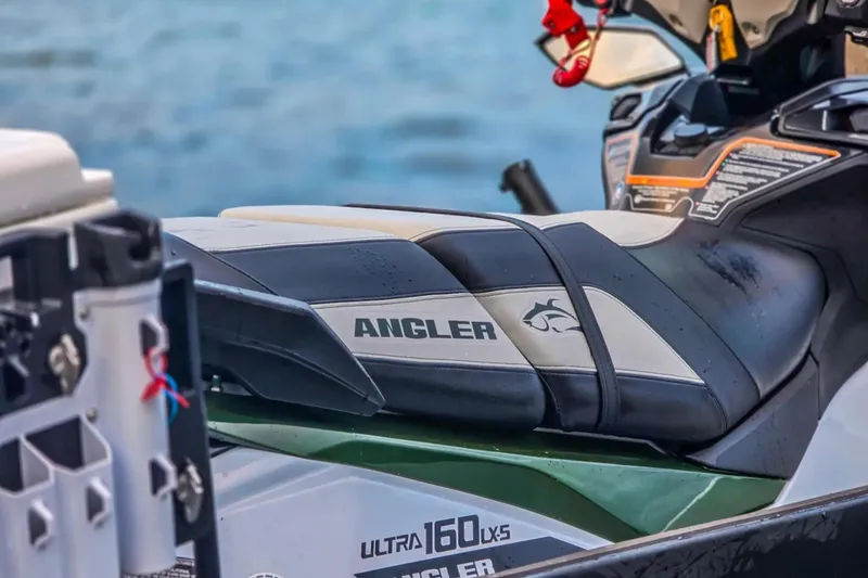 Slide: The Image of 2025 Kawasaki Ultra 160LX-S Angler jet ski with sleek design by the water. - 8