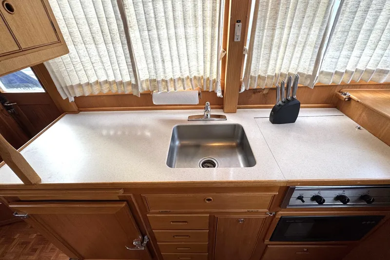 Slide: The Image of Grandbanks 36 yacht kitchen interior, 1997 model, featuring sink, countertop, and appliances. - 15