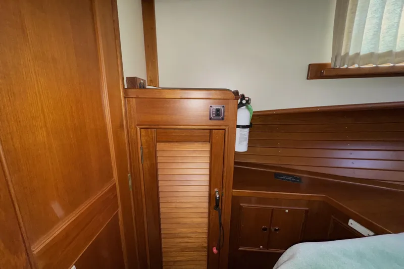 Slide: The Image of Interior of 1997 Grandbanks 36 boat with wooden cabinetry and fire extinguisher. - 19