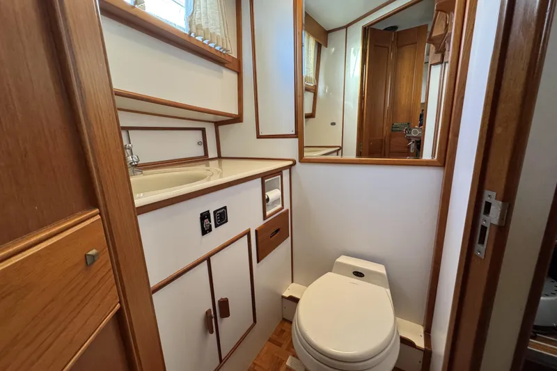 Slide: The Image of Bathroom interior of 1997 Grandbanks 36 yacht with wooden accents and modern fixtures. - 20
