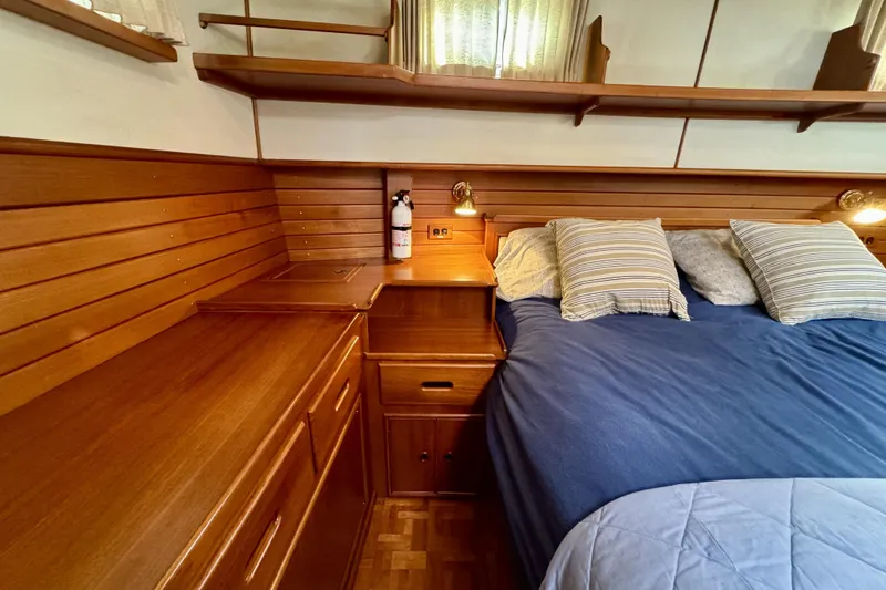 Slide: The Image of Cozy cabin interior of 1997 Grandbanks 36 with wooden furnishings and a comfortable bed. - 24