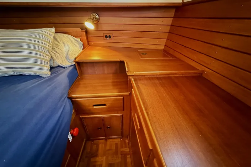 Slide: The Image of Cozy cabin interior of 1997 Grandbanks 36 with wooden furniture and bed. - 26