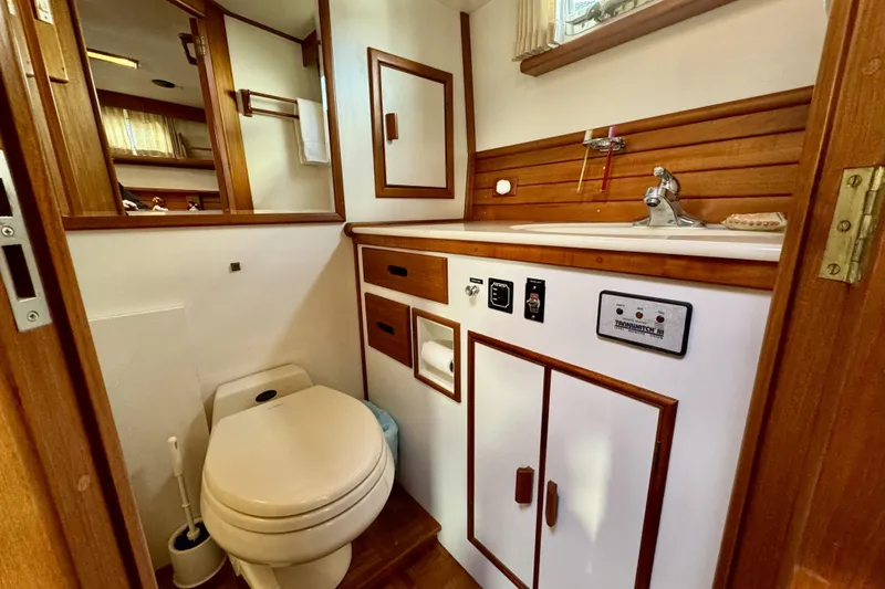 Slide: The Image of 1997 Grandbanks 36 yacht bathroom with wooden cabinetry and modern fixtures. - 28