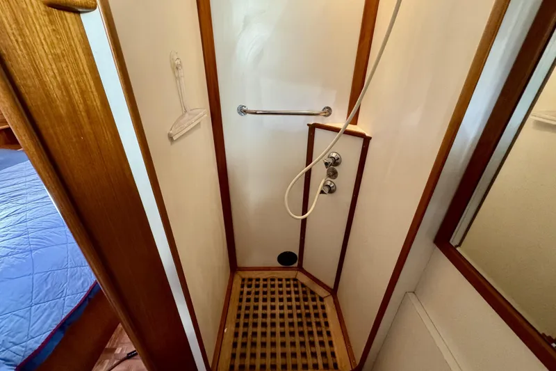 Slide: The Image of Shower area in 1997 Grandbanks 36 boat with wooden accents and modern fixtures. - 29