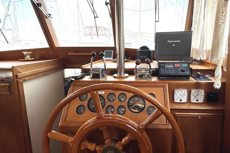 Slide: The Image of Helm of 1997 Grandbanks 36 boat with wooden wheel and navigation instruments. - 3