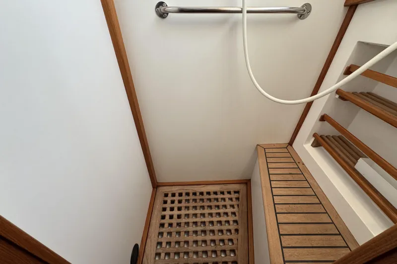 Slide: The Image of Interior of 1997 Grandbanks 36 boat, featuring wooden flooring and handrail. - 31