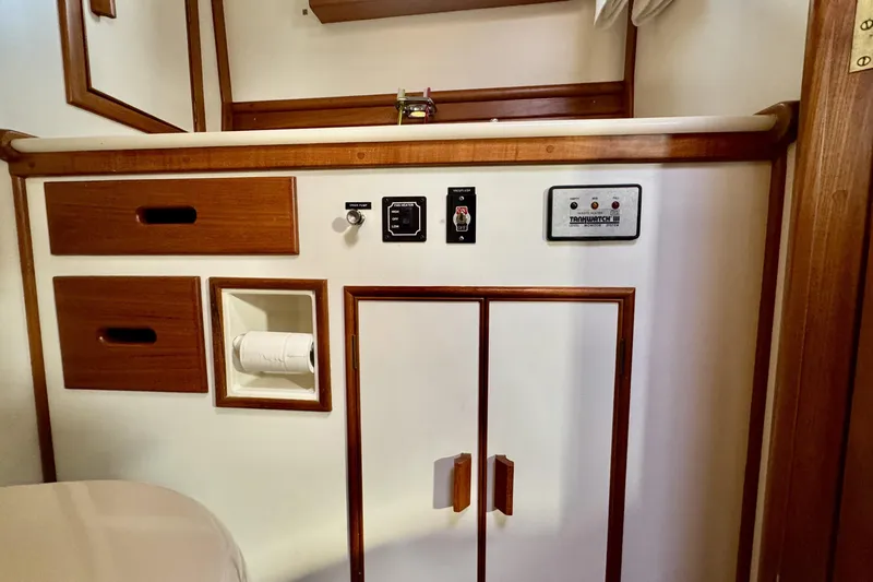 Slide: The Image of 1997 Grandbanks 36 interior with wooden cabinetry and control panel. - 33