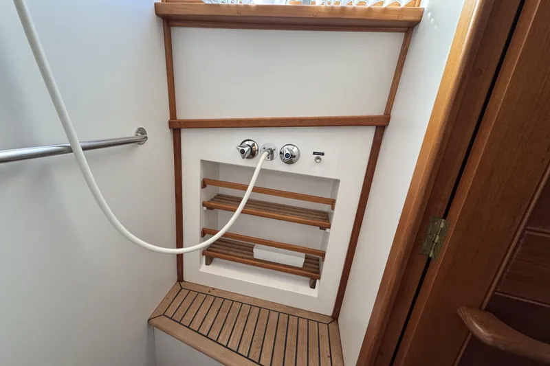 Slide: The Image of Shower area in a 1997 Grandbanks 36 boat with wooden accents and fixtures. - 34