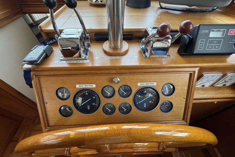 Slide: The Image of 1997 Grandbanks 36 helm with gauges, controls, and wooden finish. - 4