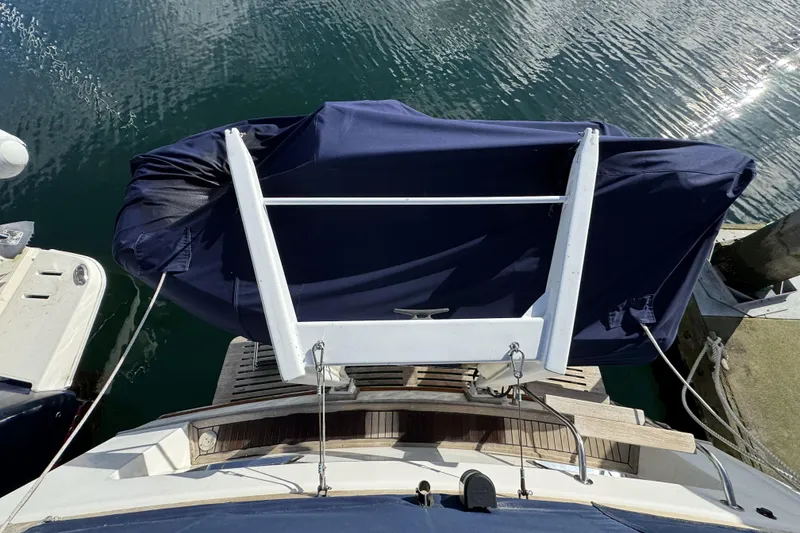 Slide: The Image of 1997 Grandbanks 36 yacht stern view with covered equipment and wooden deck. - 40