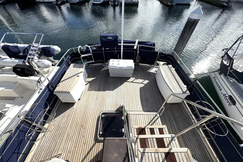 Slide: The Image of Spacious deck of 1997 Grandbanks 36 yacht with wooden flooring and seating. - 43