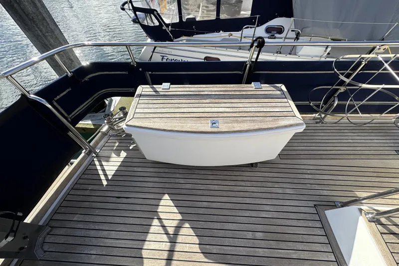 Slide: The Image of Deck of 1997 Grandbanks 36 yacht with wooden flooring and storage box. - 44