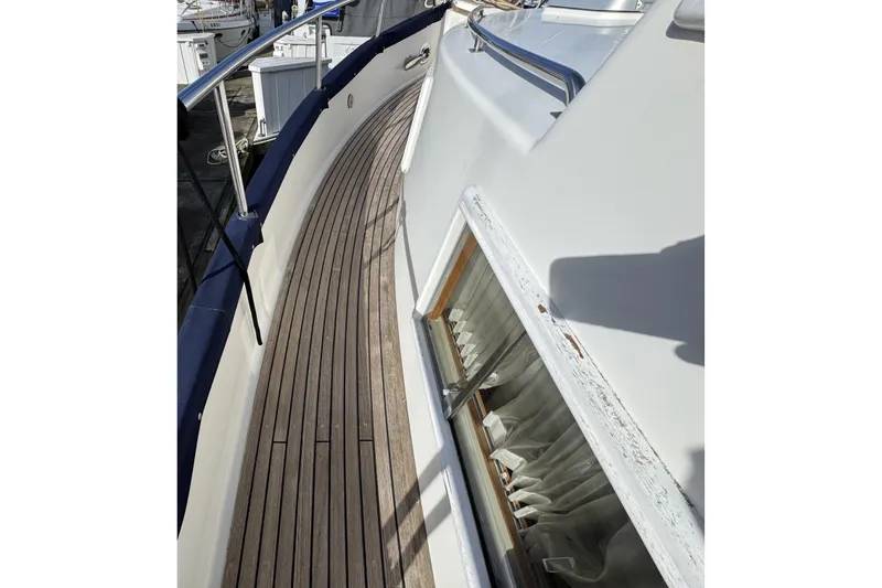 Slide: The Image of 1997 Grandbanks 36 yacht deck with wooden flooring and railing. - 46