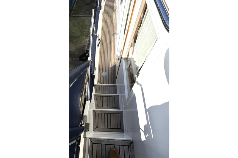 Slide: The Image of 1997 Grandbanks 36 yacht deck with wooden steps and railing. - 47