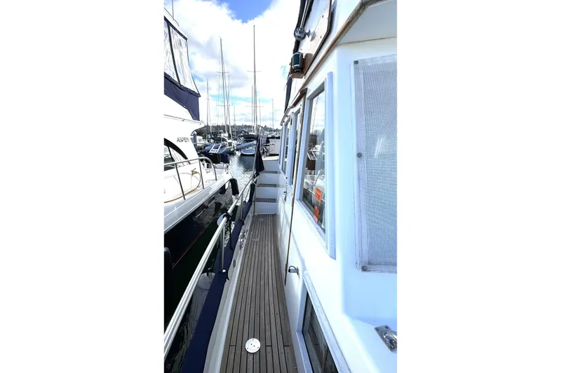 Slide: The Image of Side view of a 1997 Grandbanks 36 yacht docked at a marina. - 48
