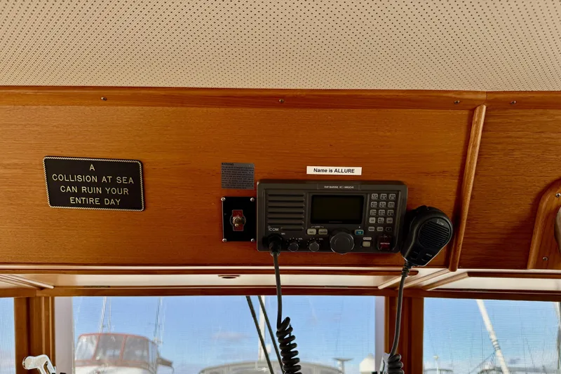 Slide: The Image of 1997 Grandbanks 36 interior with radio and safety sign, "A collision at sea can ruin your entire day." - 8