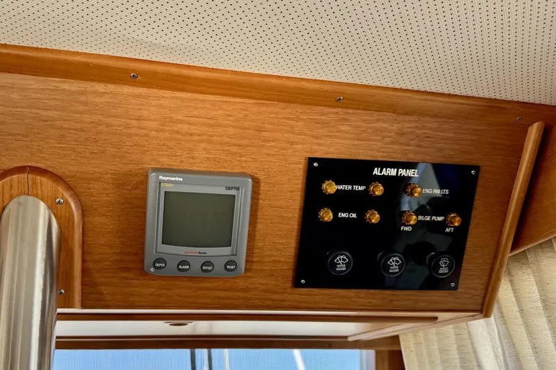 Slide: The Image of 1997 Grandbanks 36 interior with Raymarine depth display and alarm panel. - 9