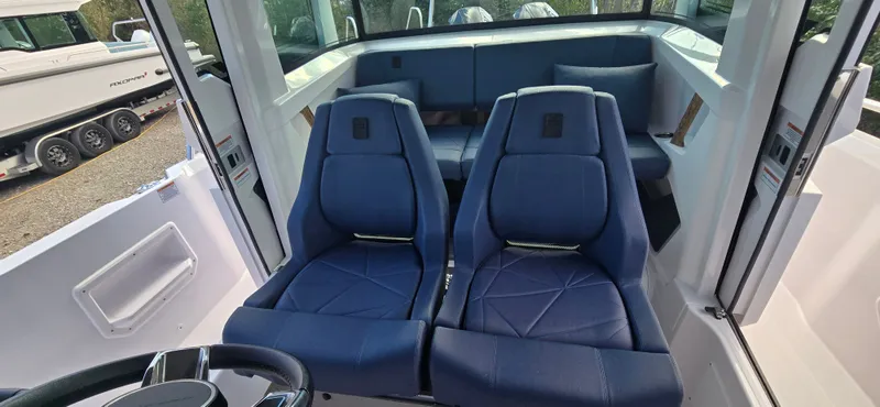 Slide: The Image of Interior of 2024 Axopar 29 boat with blue seats. - 12