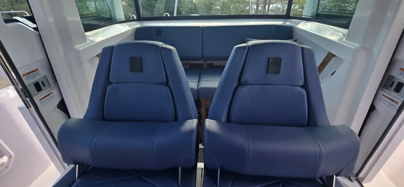 Slide: The Image of Interior of 2024 Axopar 29 boat with blue seats. - 13