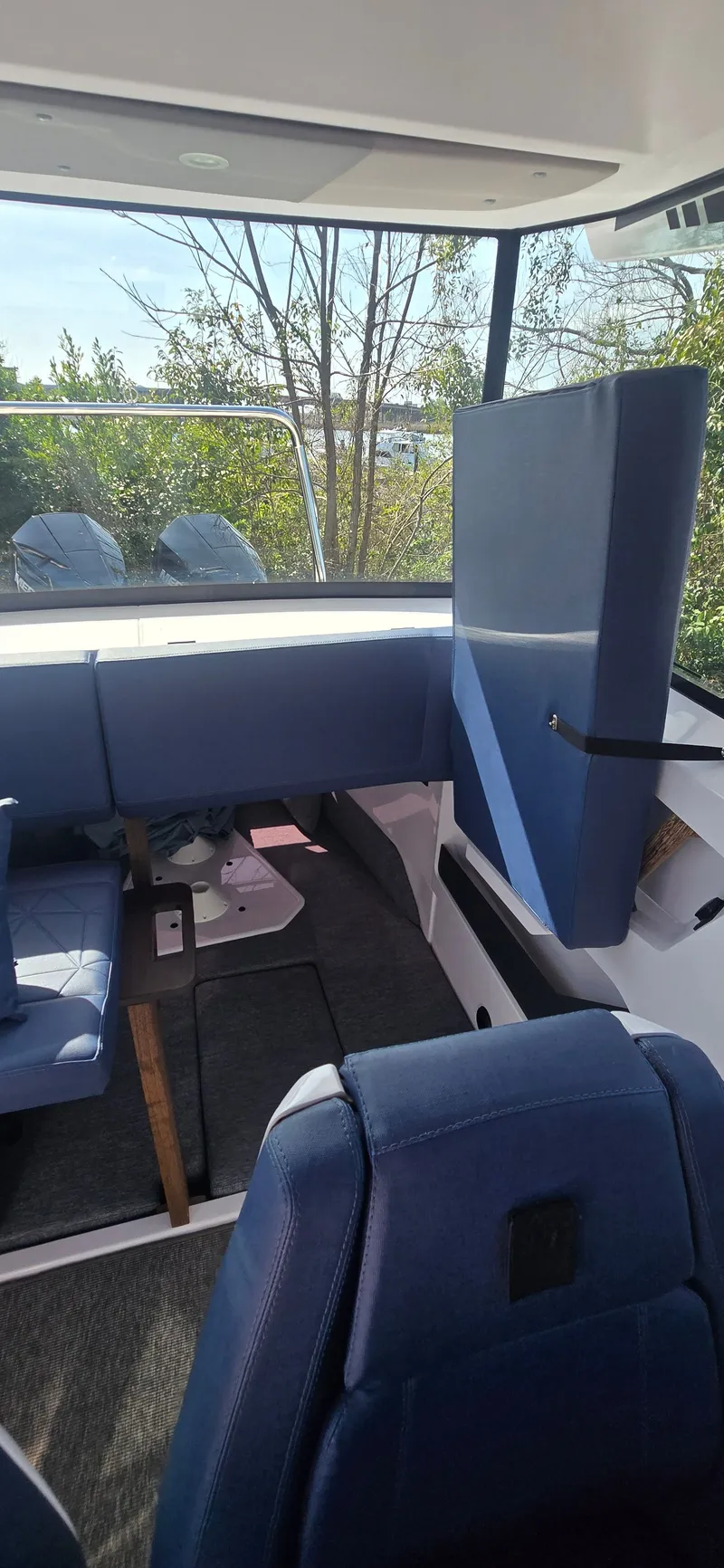 Slide: The Image of Interior of 2024 Axopar 29 boat with blue seating. - 14