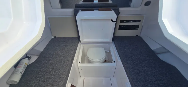 Slide: The Image of Interior of 2024 Axopar 29 featuring built-in toilet. - 25