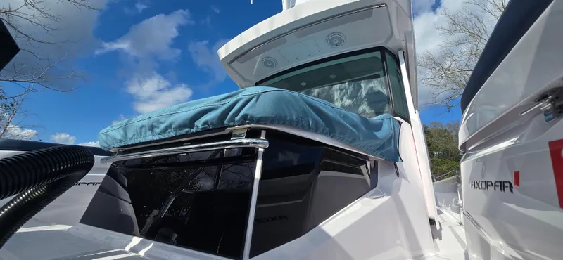 Slide: The Image of Axopar 29 boat 2024, close-up with blue sky. - 6