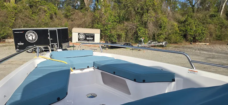 Slide: The Image of 2024 Axopar 29 boat with blue cushions outdoors. - 7