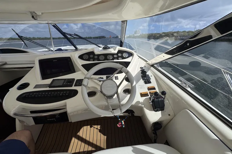 Slide: The Image of Cockpit of 2000 Sunseeker Predator 56 yacht with steering wheel and control panel. - 13