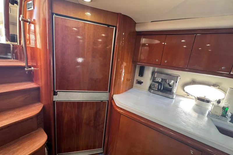 Slide: The Image of Luxurious Sunseeker Predator 56 yacht kitchen interior with wood cabinetry and modern appliances, 2000 model. - 17