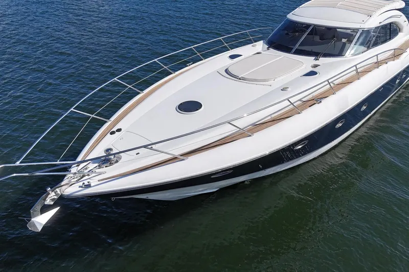 Slide: The Image of Luxury Sunseeker Predator 56 yacht from 2000 on calm water, showcasing sleek design. - 2