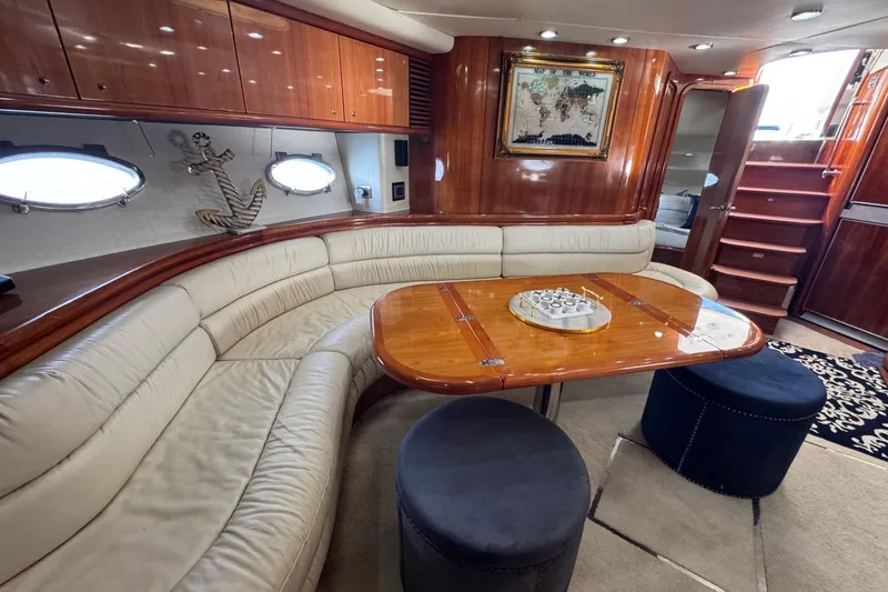 Slide: The Image of Luxurious interior of 2000 Sunseeker Predator 56 yacht with elegant seating and wooden finishes. - 24