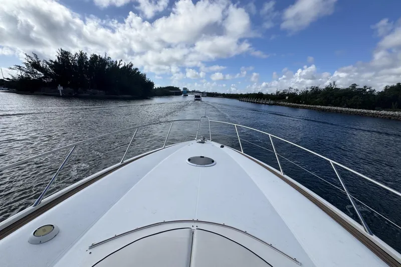 Slide: The Image of Bow view of 2000 Sunseeker Predator 56 yacht cruising on a scenic waterway. - 4