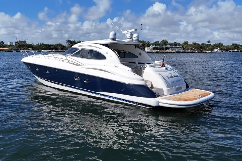Slide: The Image of Sunseeker Predator 56 yacht, 2000 model, cruising on a sunny day with scenic waterfront views. - 5