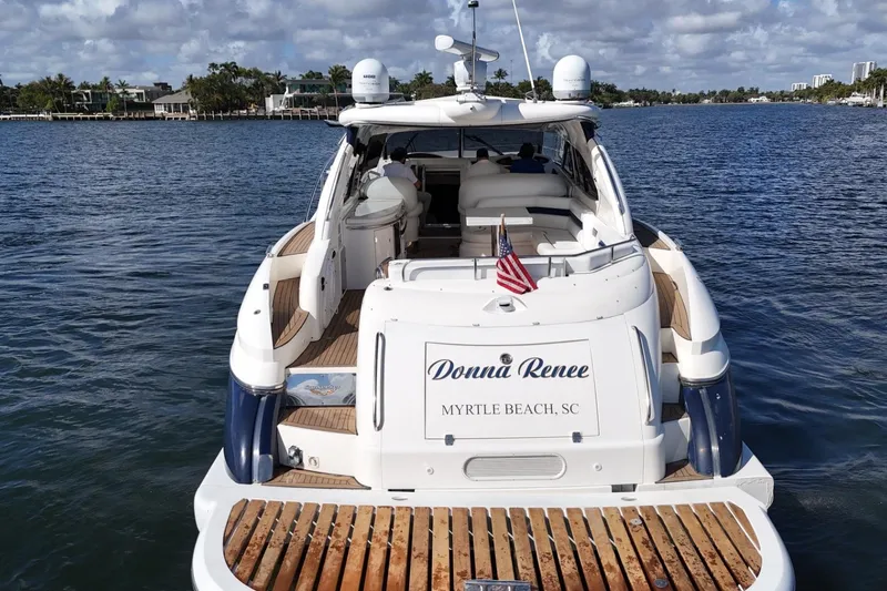 Slide: The Image of Sunseeker Predator 56 yacht, 2000 model, docked in Myrtle Beach, SC, with American flag. - 7